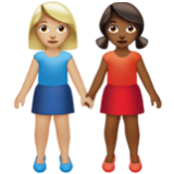 Apple(iPhone) Women Holding Hands: Medium-Light Skin Tone, Medium-Dark Skin Tone Emoji